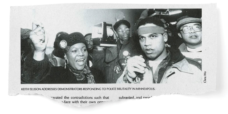 Several African American people seen chest up, a woman in a hat in the foreground with her hand up, Keith Ellison in the front right possibly holding a microphone.