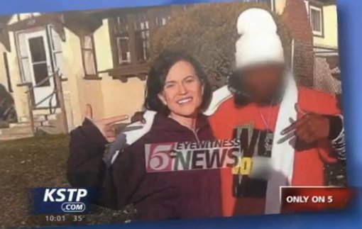 Mayor Betsy hodges stands next to a man whose face has been blurred out, both people in the photo are pointing at each other.